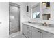Modern bathroom with a marble surround shower, double sinks with marble countertops, and stylish fixtures at 289 2Nd St, Fayetteville, GA 30214