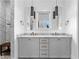 Bright bathroom with double sinks, marble countertops, modern lighting, and a marble surround shower at 289 2Nd St, Fayetteville, GA 30214