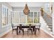 Sunlit dining room with hardwood floors, modern chandelier, and views of the backyard at 289 2Nd St, Fayetteville, GA 30214