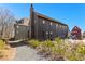 Exterior of a modern home featuring a stone driveway, lush landscaping, and a dark wood exterior at 289 2Nd St, Fayetteville, GA 30214