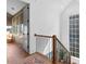 Hallway with wood floors, stylish black iron railing, and natural light from window at 289 2Nd St, Fayetteville, GA 30214