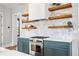 Close up of a modern kitchen with open shelving, white countertops and stainless steel appliances at 289 2Nd St, Fayetteville, GA 30214