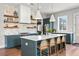 Well-designed kitchen featuring custom cabinetry, open shelving, and a spacious island at 289 2Nd St, Fayetteville, GA 30214