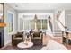 Bright, open-concept living area with large windows, hardwood floors, and a cozy fireplace at 289 2Nd St, Fayetteville, GA 30214