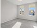 Empty bedroom with two windows and carpet flooring at 1692 Juniper Berry Way, Loganville, GA 30052