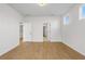 Spacious bedroom with hardwood floors, white walls, and two entry doors at 1692 Juniper Berry Way, Loganville, GA 30052