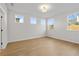 Bright and airy bedroom with hardwood floors and natural light from the large windows at 1692 Juniper Berry Way, Loganville, GA 30052