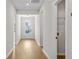 Well-lit hallway showcasing hardwood floors and access to the laundry, leading to the back door at 1692 Juniper Berry Way, Loganville, GA 30052