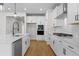 Modern kitchen with white cabinets, stainless steel appliances, and an island with a sink at 1692 Juniper Berry Way, Loganville, GA 30052