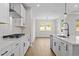 Modern kitchen featuring white cabinets, stainless steel appliances, and a view into the dining area, perfect for gatherings at 1692 Juniper Berry Way, Loganville, GA 30052