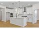 Bright kitchen featuring white cabinets, stainless steel appliances, a center island, and wood flooring at 1692 Juniper Berry Way, Loganville, GA 30052