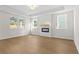 Bright living room featuring tray ceiling, an electric fireplace with a modern mantel, and large windows at 1692 Juniper Berry Way, Loganville, GA 30052