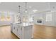 Bright open-concept living space combines the kitchen and Gathering room, with a fireplace feature at 1692 Juniper Berry Way, Loganville, GA 30052