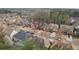 An aerial view showcases a residential neighborhood with well-maintained houses and tree-lined streets at 2126 Roberts View Trl, Buford, GA 30519