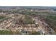 Aerial perspective of homes nestled amongst trees, combining residential appeal with a serene natural environment at 2126 Roberts View Trl, Buford, GA 30519