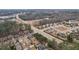 A high-angle shot displays houses along a road, bordered by trees, and a view of the surrounding area at 2126 Roberts View Trl, Buford, GA 30519