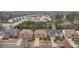 Aerial view showcasing a neighborhood with neat lawns, driveways, and mature trees, highlighting the community's serene atmosphere at 2126 Roberts View Trl, Buford, GA 30519