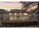Charming two-story home with a spacious backyard and serene outdoor setting at sunset at 2126 Roberts View Trl, Buford, GA 30519