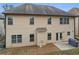 Exterior view of home with beige siding, a small patio area, and green landscaping at 2126 Roberts View Trl, Buford, GA 30519
