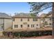Two-story home featuring lush greenery, spacious backyard, and charming outdoor living at 2126 Roberts View Trl, Buford, GA 30519