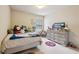 Inviting bedroom featuring bright natural light, decorative pillows, and plush furnishings at 2126 Roberts View Trl, Buford, GA 30519