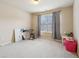 Bedroom with neutral tones, carpeting, a window, and simple decor creating a blank canvas for customization at 2126 Roberts View Trl, Buford, GA 30519