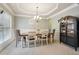 An elegant formal dining room features a modern chandelier and decorative wall accents at 2126 Roberts View Trl, Buford, GA 30519