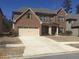 Charming two-story brick home with a well-maintained lawn and a two-car garage at 2126 Roberts View Trl, Buford, GA 30519