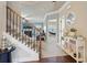 This inviting foyer features a staircase with iron spindles, a hall table, and neutral paint at 2126 Roberts View Trl, Buford, GA 30519