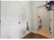 Hallway with utility closet leading to a laundry room, creating a practical and organized space at 2126 Roberts View Trl, Buford, GA 30519