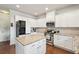 Modern kitchen with white cabinets, granite countertops, stainless steel appliances, and a center island at 2126 Roberts View Trl, Buford, GA 30519