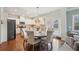 Eat-in kitchen features a round table, modern light fixture and leads into a fully appointed kitchen at 2126 Roberts View Trl, Buford, GA 30519