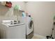 Laundry room featuring a washing machine, dryer, shelving, and cleaning supplies at 2126 Roberts View Trl, Buford, GA 30519