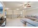 Open living space with railing, neutral carpet, ceiling fan, and a large sectional sofa at 2126 Roberts View Trl, Buford, GA 30519