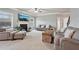 Cozy living room featuring plush seating, fireplace, and natural light from large windows at 2126 Roberts View Trl, Buford, GA 30519