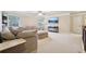 Spacious living room with plush sofa, ottoman, ceiling fan, and a mounted TV at 2126 Roberts View Trl, Buford, GA 30519