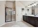 Bathroom showcasing a shower, vanity with dark cabinets, and tile flooring at 2126 Roberts View Trl, Buford, GA 30519