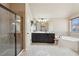 Bathroom featuring a separate shower, soaking tub, and vanity with dark cabinets at 2126 Roberts View Trl, Buford, GA 30519