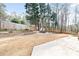 Large backyard with a stone-walled seating area, perfect for relaxing outdoors at 2826 Cobb Place Manor Ct, Marietta, GA 30066