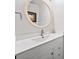 Bright bathroom with a modern sink, white cabinets and large round mirror at 2826 Cobb Place Manor Ct, Marietta, GA 30066