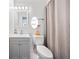 Bathroom featuring a modern sink vanity, toilet and shower behind a gray and white patterned curtain at 2826 Cobb Place Manor Ct, Marietta, GA 30066