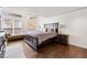 Spacious bedroom with hardwood floors, large windows, and a comfortable bed at 2826 Cobb Place Manor Ct, Marietta, GA 30066