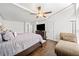 Cozy bedroom featuring a queen-sized bed, ceiling fan, and ample natural light at 2826 Cobb Place Manor Ct, Marietta, GA 30066