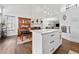 Open-concept kitchen with island, hardwood floors leading to dining area with built-in cabinet at 2826 Cobb Place Manor Ct, Marietta, GA 30066