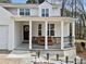 Inviting front porch features decorative railing, seating, a cheerful wreath, and manicured landscaping at 2826 Cobb Place Manor Ct, Marietta, GA 30066