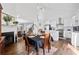Open-concept kitchen features stainless appliances, island, and hardwood floors with adjoining dining area at 2826 Cobb Place Manor Ct, Marietta, GA 30066