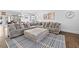 Comfortable living room featuring a large sectional sofa, ottoman, and patterned rug at 2826 Cobb Place Manor Ct, Marietta, GA 30066
