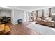 Spacious living room with hardwood floors, a comfortable leather sofa, and large windows at 2826 Cobb Place Manor Ct, Marietta, GA 30066