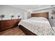 Inviting primary bedroom suite boasts wood floors, a dresser, and a plush bed at 2826 Cobb Place Manor Ct, Marietta, GA 30066