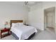 Cozy bedroom boasts a plush bed, a dark wooden nightstand, and soft carpeting at 1175 Glenridge Pl, Atlanta, GA 30342